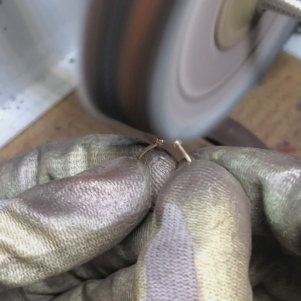 Jeweler polishing 14k yellow gold open cuff ring